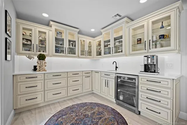 a view of a kitchen with stainless steel appliances wooden floor dining table and chairs