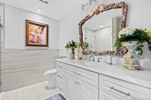 a row of palm trees in front of house