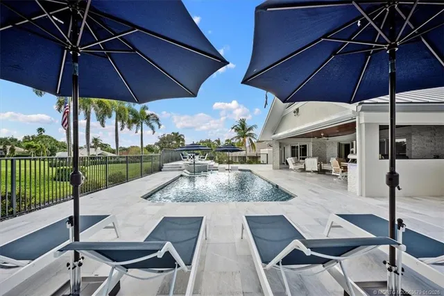 an aerial view of a house with yard and trees all around