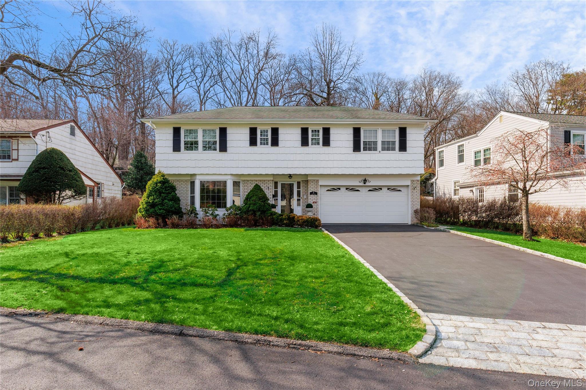 14 Loewen Court Rye, NY 10580 - Photo 22 of 25 Alternate view of the home featuring driveway with a belgian block skirt