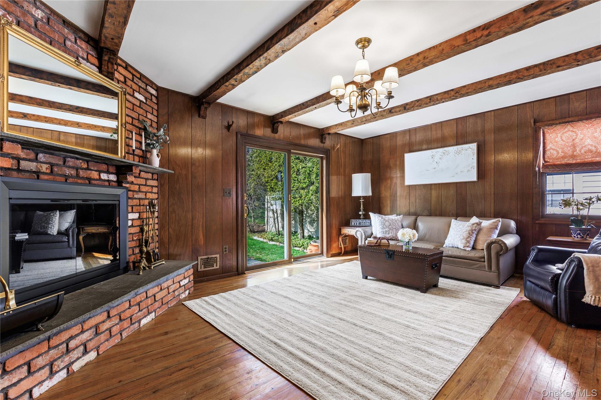 14 Loewen Court Rye, NY 10580 - Photo 9 of 25 Family Room with fireplace and access to patio and yard