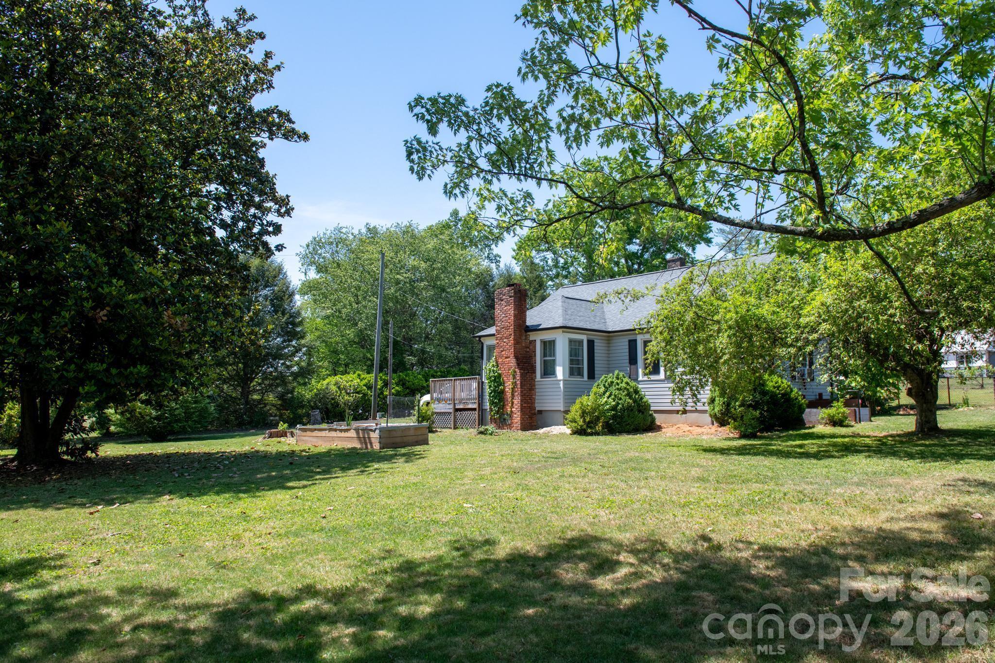 828 Jamestown Road Morganton, NC 28655 - Photo 36 of 36 a view of a house with a big yard and large trees