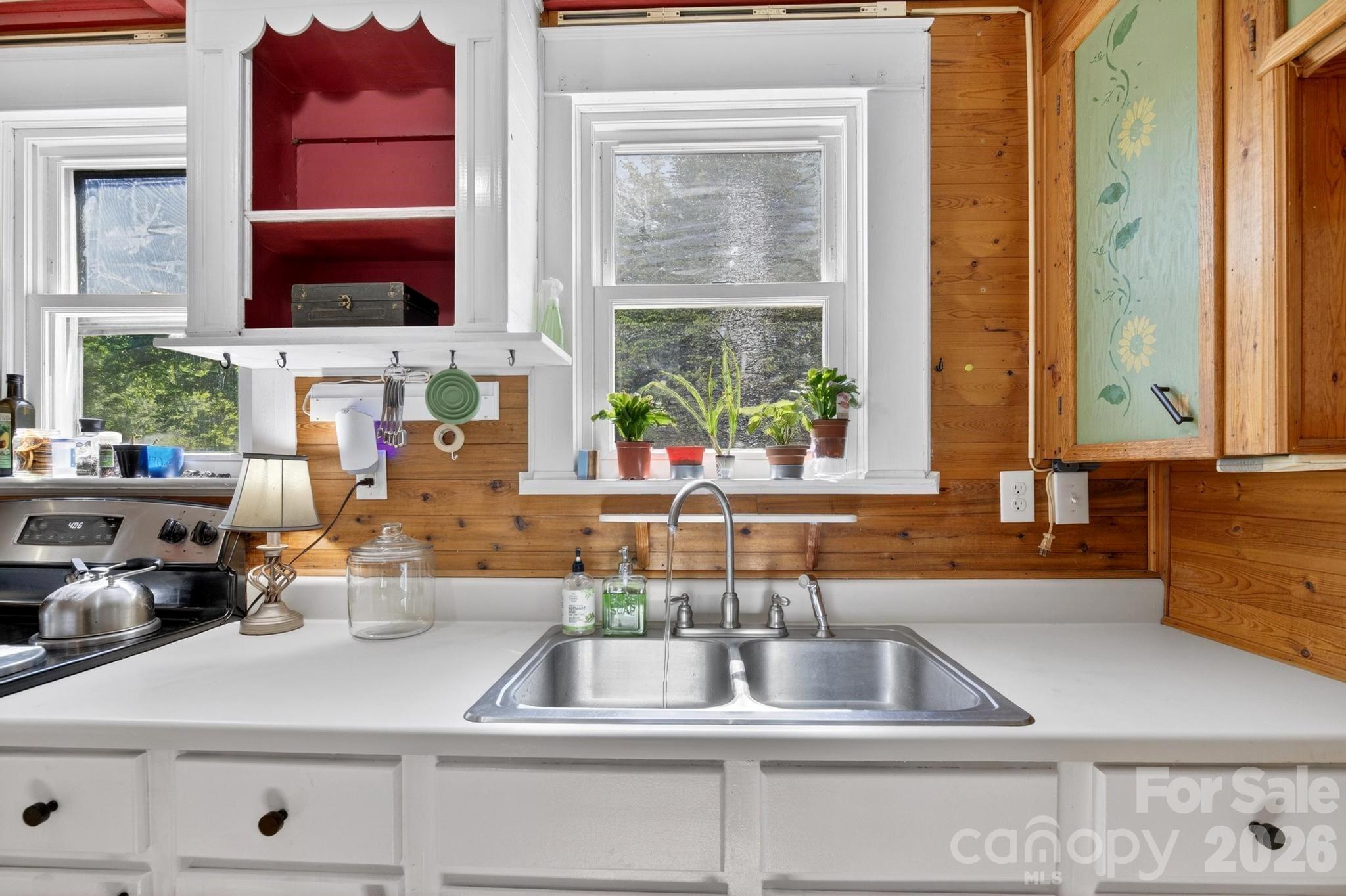 828 Jamestown Road Morganton, NC 28655 - Photo 7 of 36 a kitchen with sink a window and a potted plant