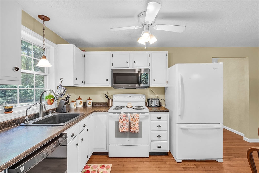 548 Reservoir Road Lunenburg, MA 01462 - Photo 20 of 34 a kitchen with stainless steel appliances a refrigerator sink and cabinets