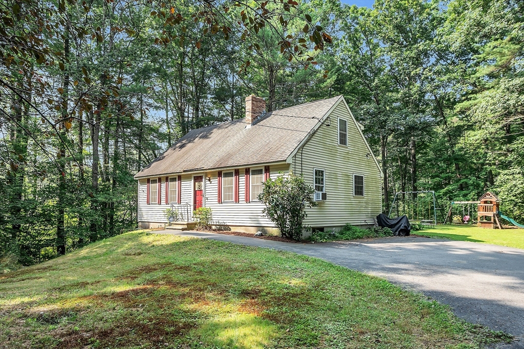 548 Reservoir Road Lunenburg, MA 01462 - Photo 3 of 34 a front view of a house with garden
