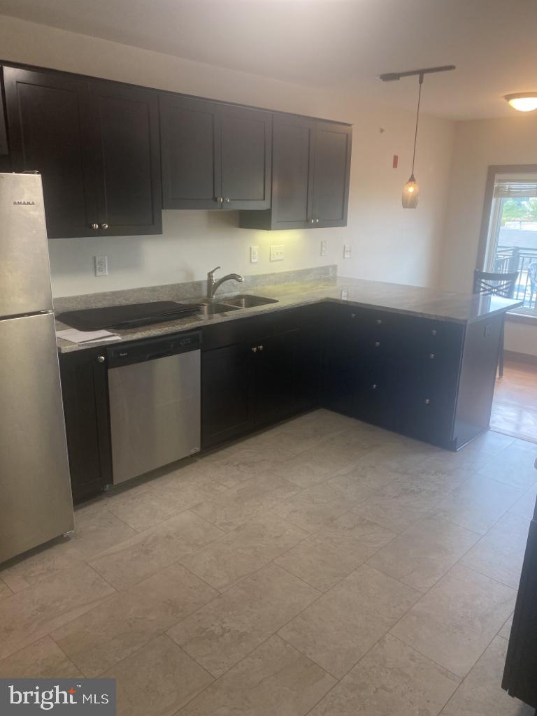 443 Millwood Avenue, Unit 2 Winchester, VA 22601 - Photo 1 of 3 a kitchen with kitchen island a sink stainless steel appliances and cabinets