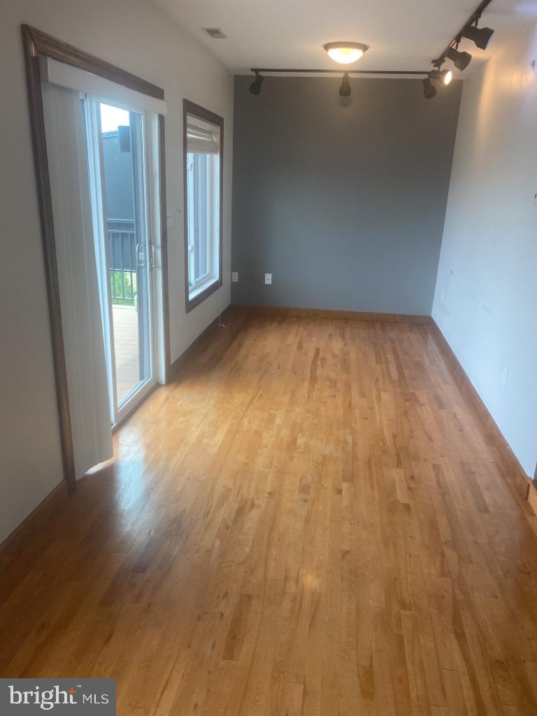 443 Millwood Avenue, Unit 2 Winchester, VA 22601 - Photo 2 of 3 wooden floor in an empty room with a window