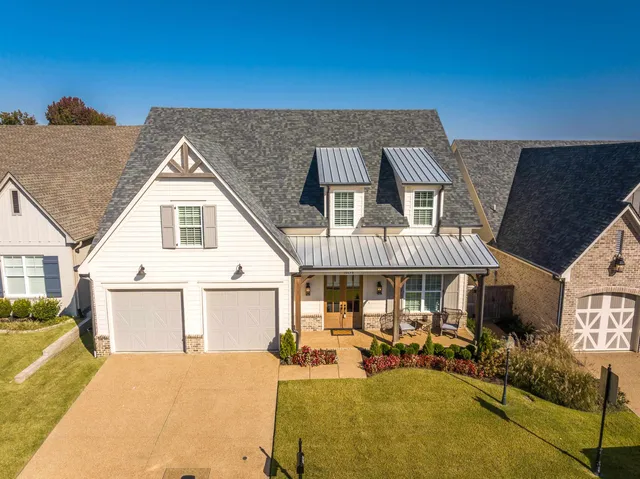 a front view of a house with patio outdoor seating and covered with couches