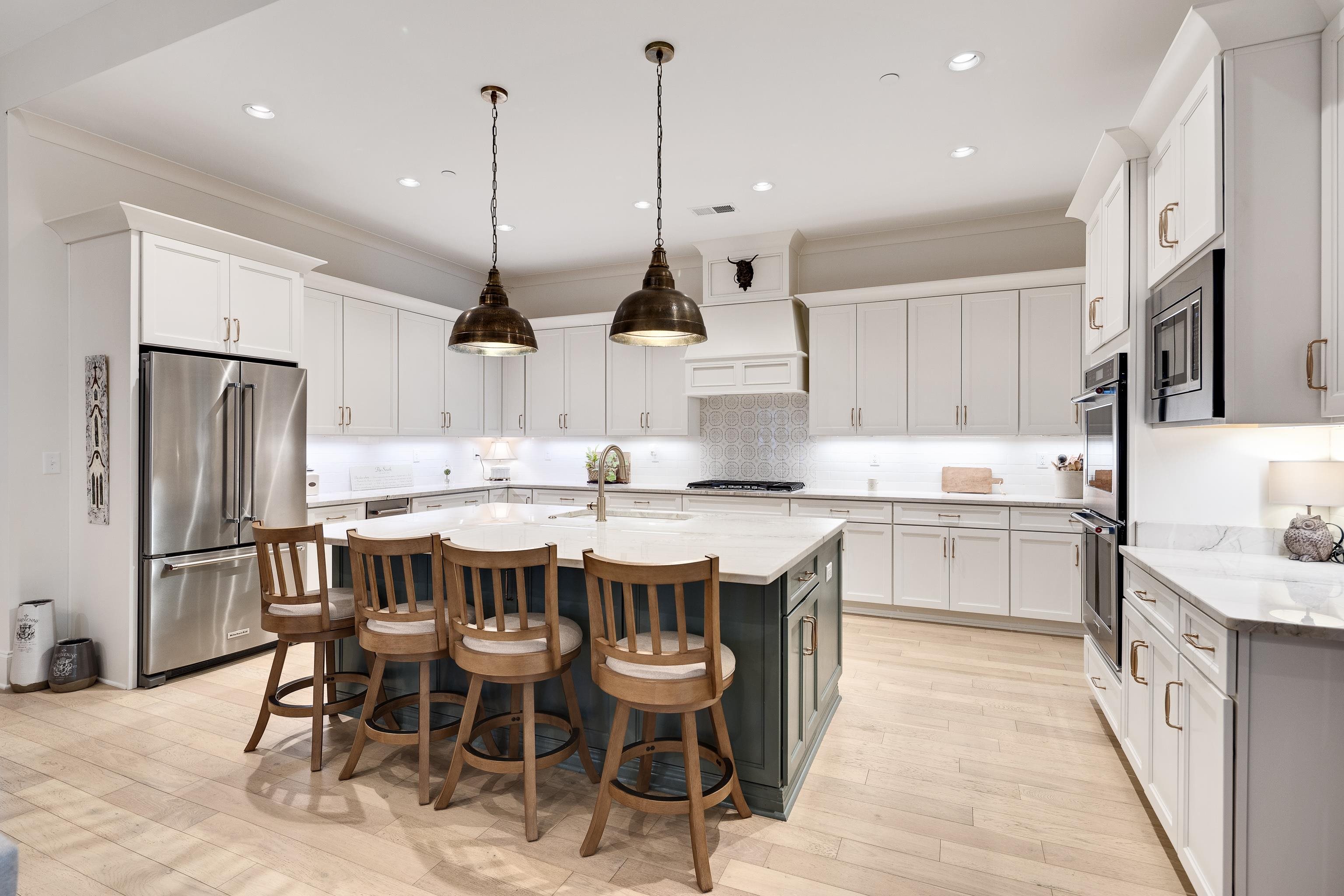10138 Cliveden Circle South Collierville, TN 38017 - Photo 13 of 39 a kitchen with stainless steel appliances granite countertop a kitchen island a stove a table and chairs