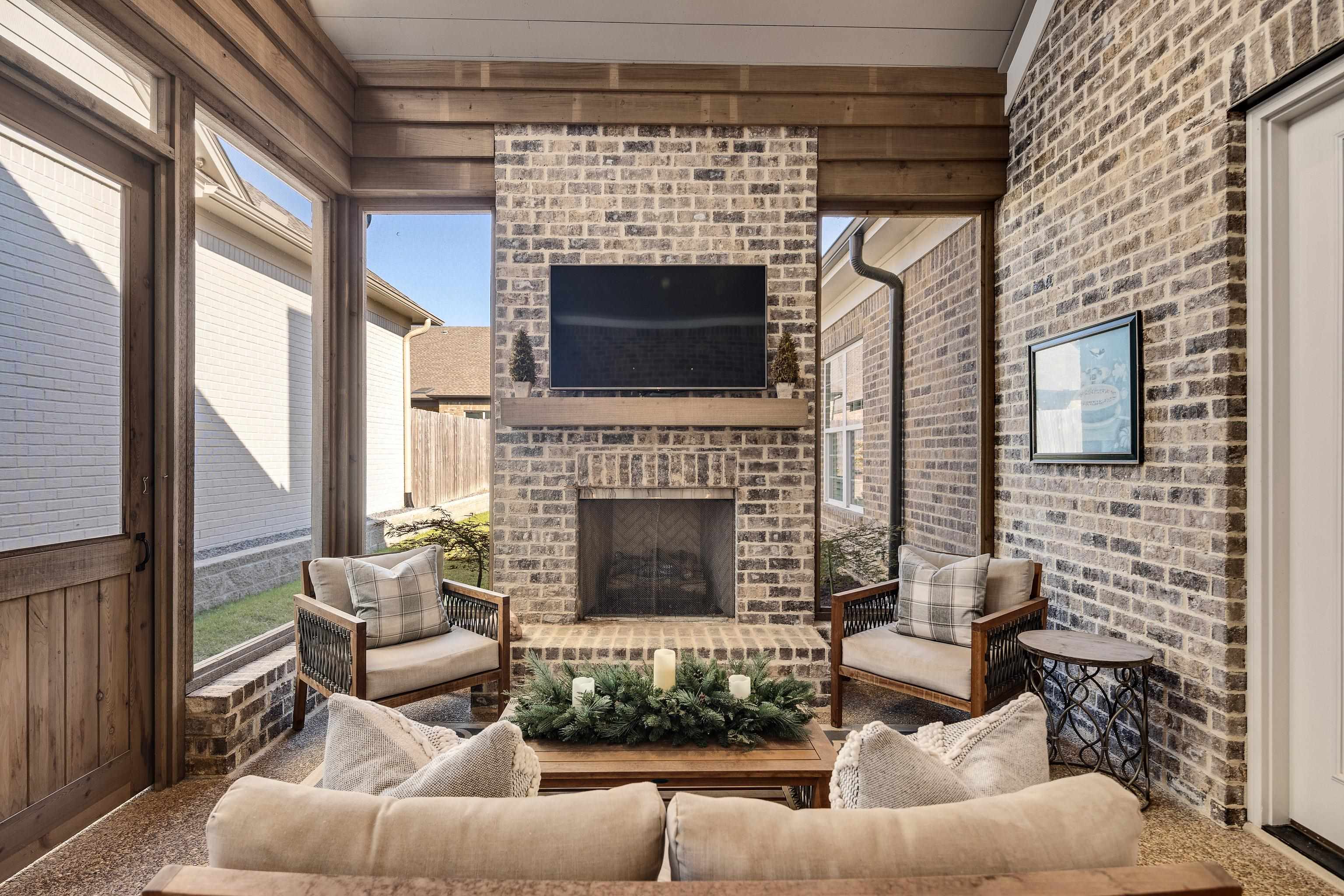 10138 Cliveden Circle South Collierville, TN 38017 - Photo 34 of 39 a living room with furniture a fireplace and a floor to ceiling window