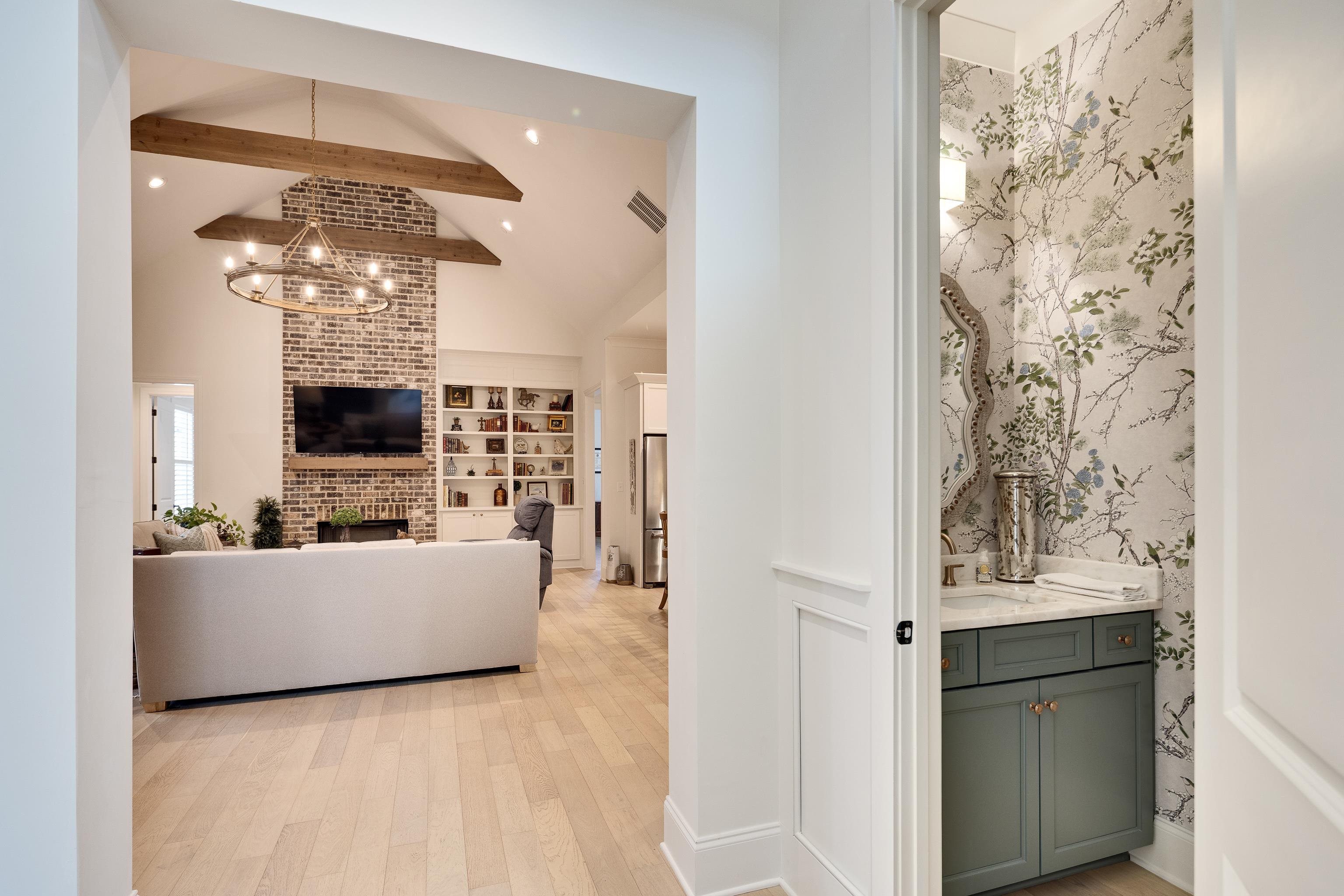 10138 Cliveden Circle South Collierville, TN 38017 - Photo 8 of 39 a living room with furniture a fireplace and a chandelier