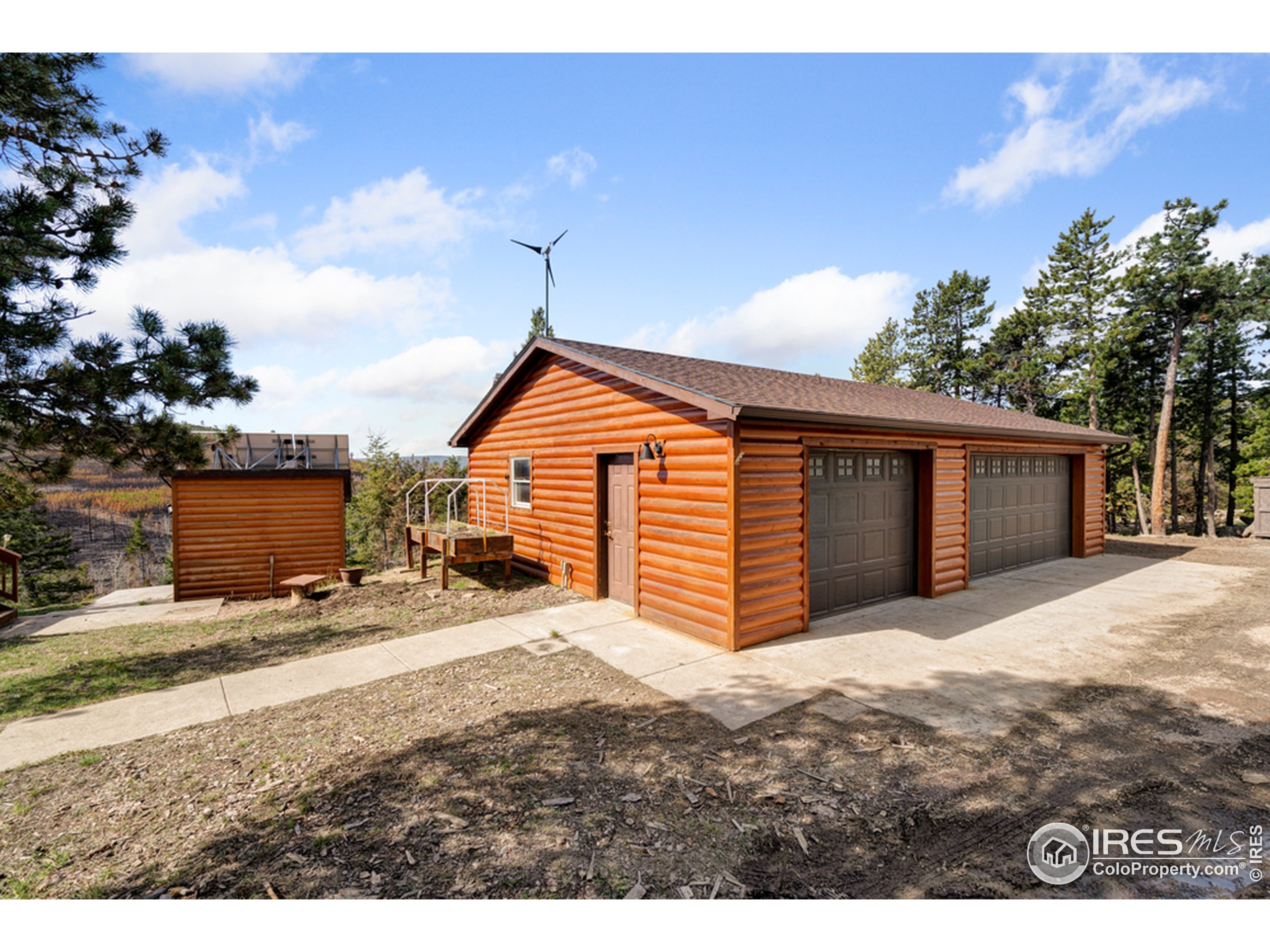 1075 Meadows Drive Drake, CO 80515 - Photo 14 of 30 a view of an house with backyard and a tree
