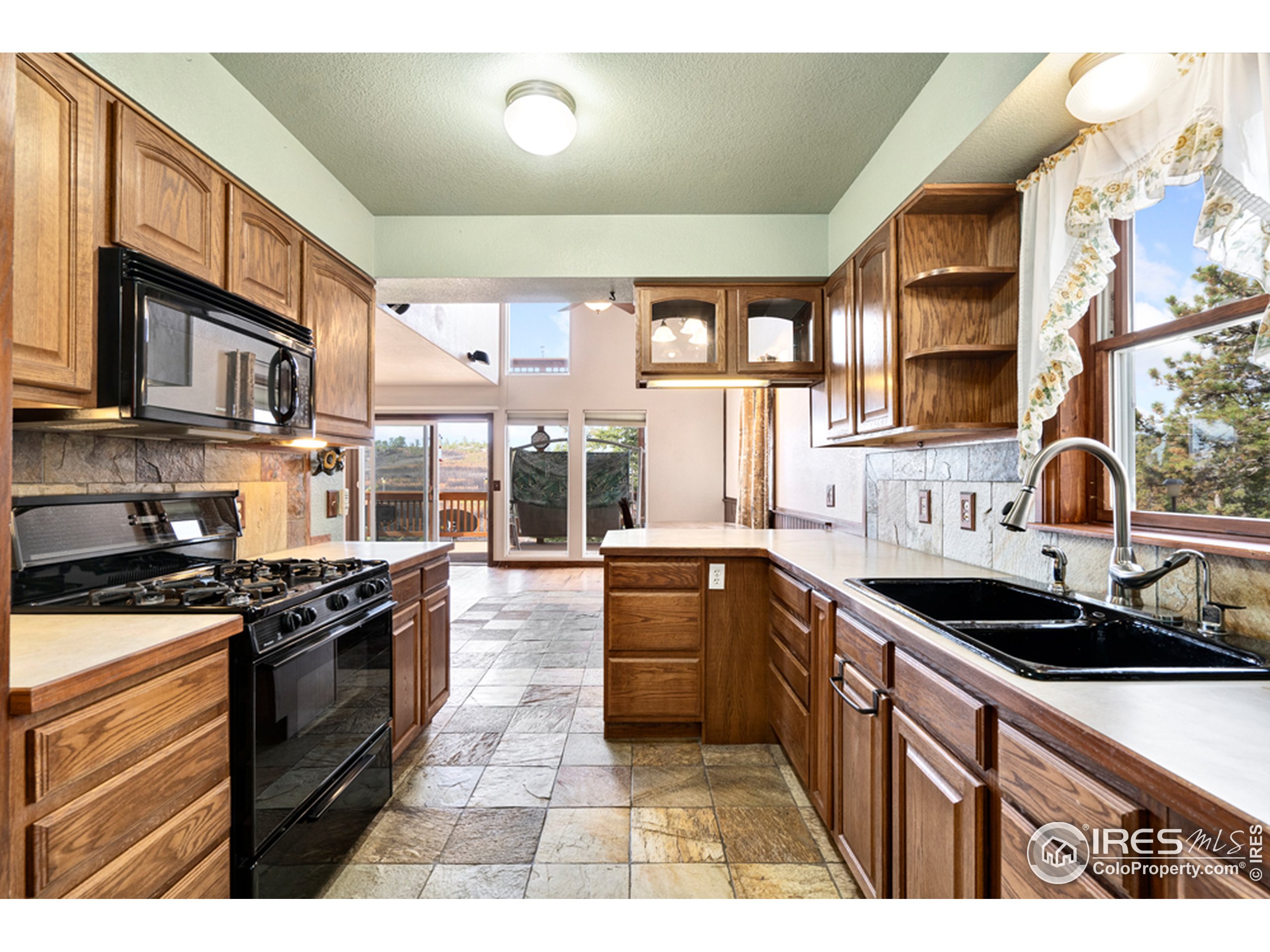 1075 Meadows Drive Drake, CO 80515 - Photo 10 of 30 a kitchen with stainless steel appliances granite countertop a stove a sink and a microwave