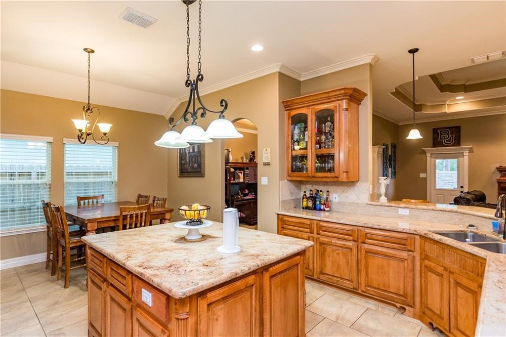 1306 Keenland Road Corpus Christi, TX 78418 - Photo 2 of 26 a kitchen with center island table and chairs