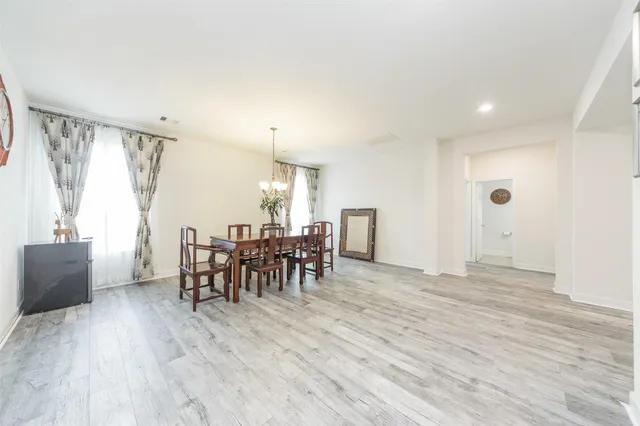 a view of a a dining room with furniture window and wooden floor
