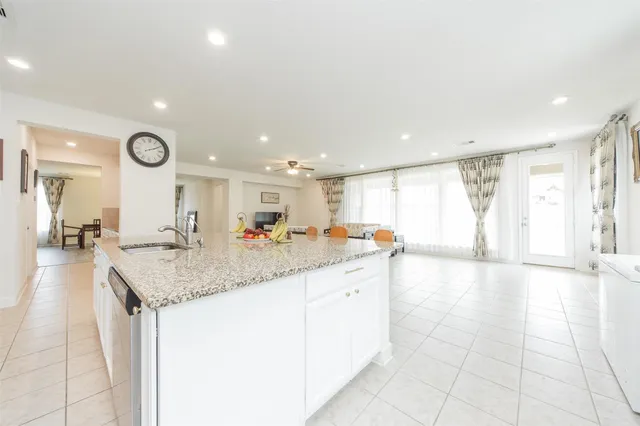 a hall with a sink and a large mirror