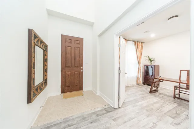 a view of a hallway with closet and bathroom