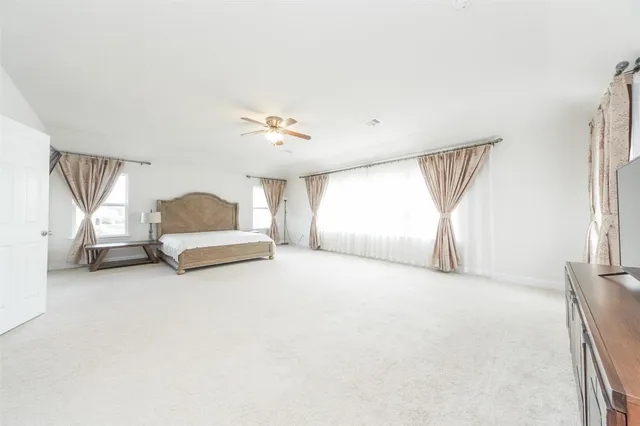 a big room with closet and a chandelier