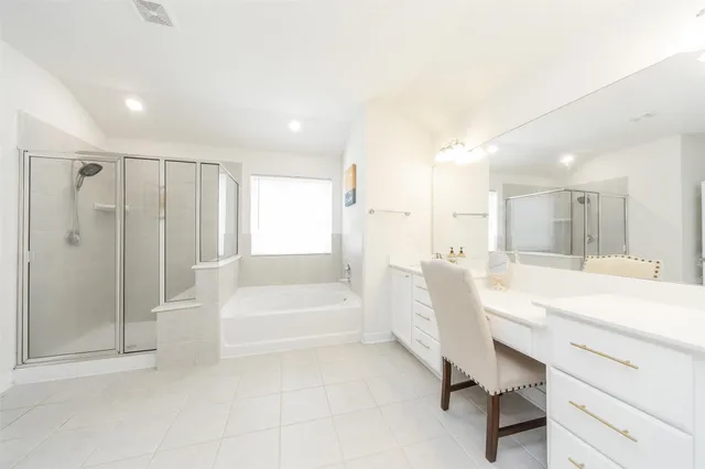 a bathroom with a bathtub a sink and a shower