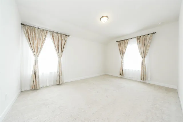 an empty room with windows and closet