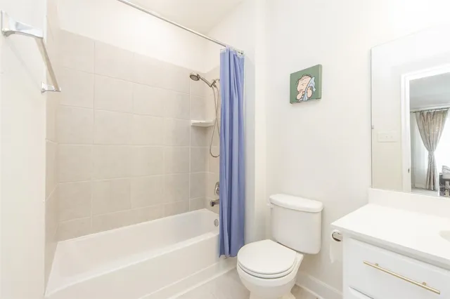 a white toilet sitting next to a bath tub
