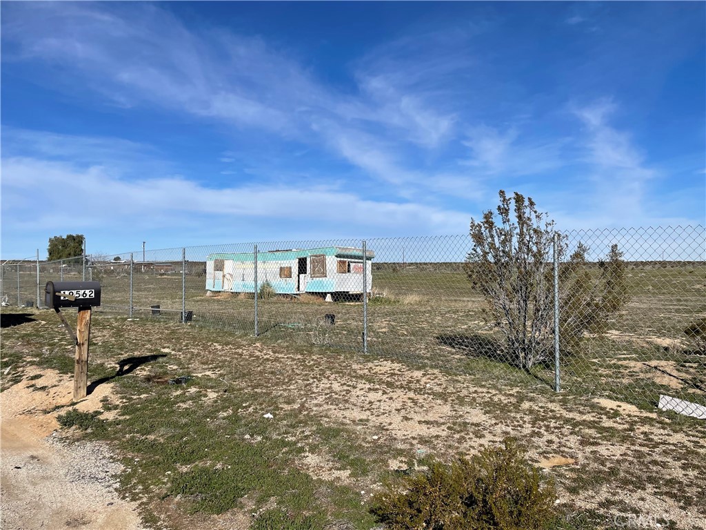 196 West Ave G Lancaster, CA 93535 - Photo 2 of 3 a view of a dry yard with wooden fence