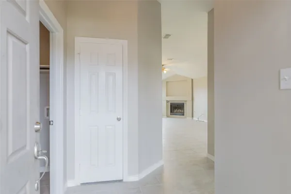 a view of a hallway with wooden shelves