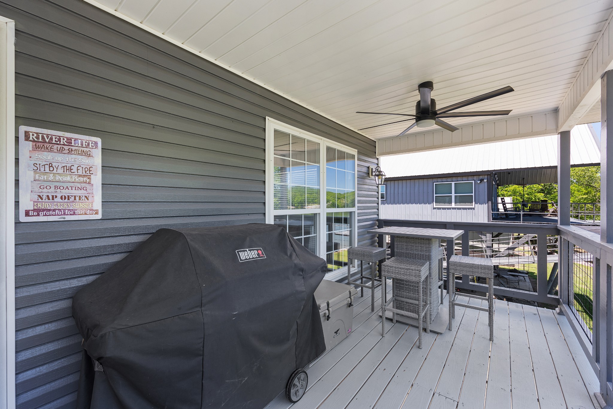 958 Pevahouse Camp Lane Decaturville, TN 38329 - Photo 5 of 32 a roof deck with a dining table and chairs with wooden floor