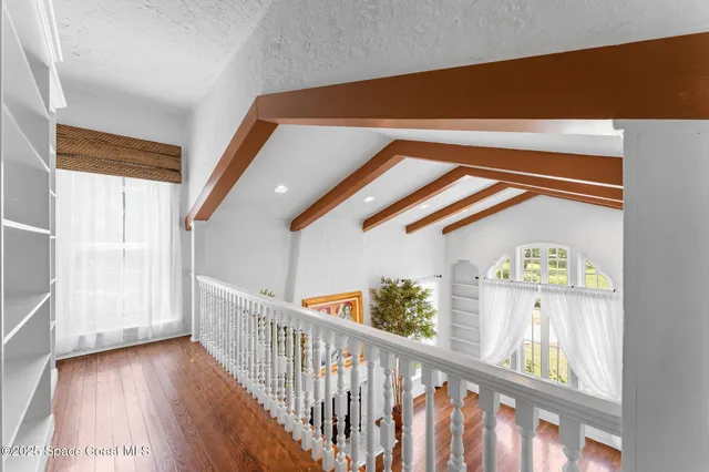 a living room with a fireplace and a potted plant