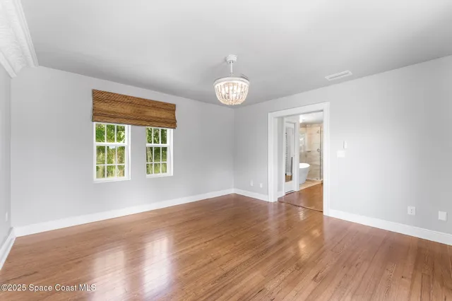 a living room with furniture a wooden floor and next to a window