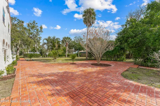 a view of empty room with wooden floor and fireplace