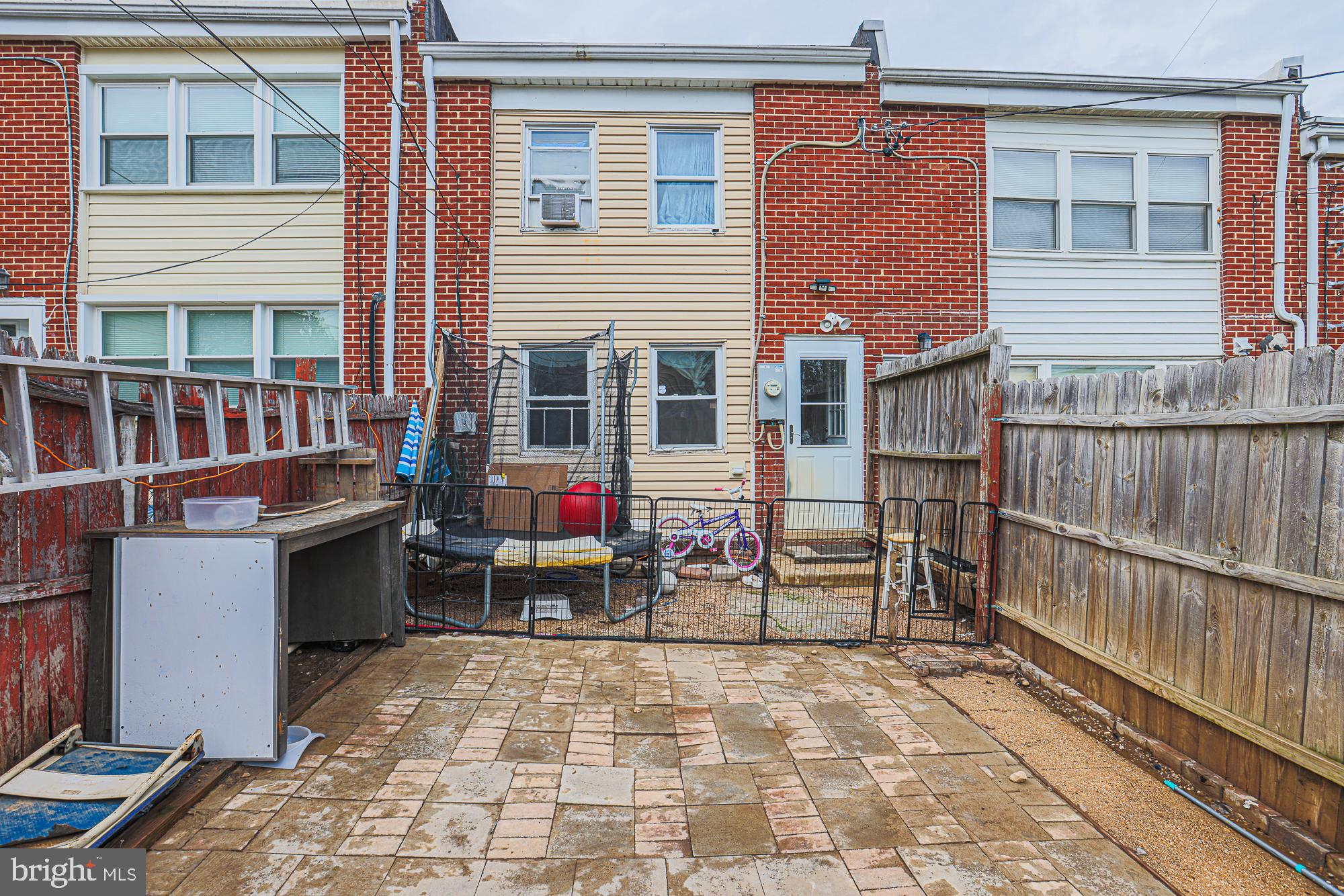 2707 Norfen Road Baltimore, MD 21227 - Photo 11 of 11 a backyard of a house with barbeque oven table and chairs