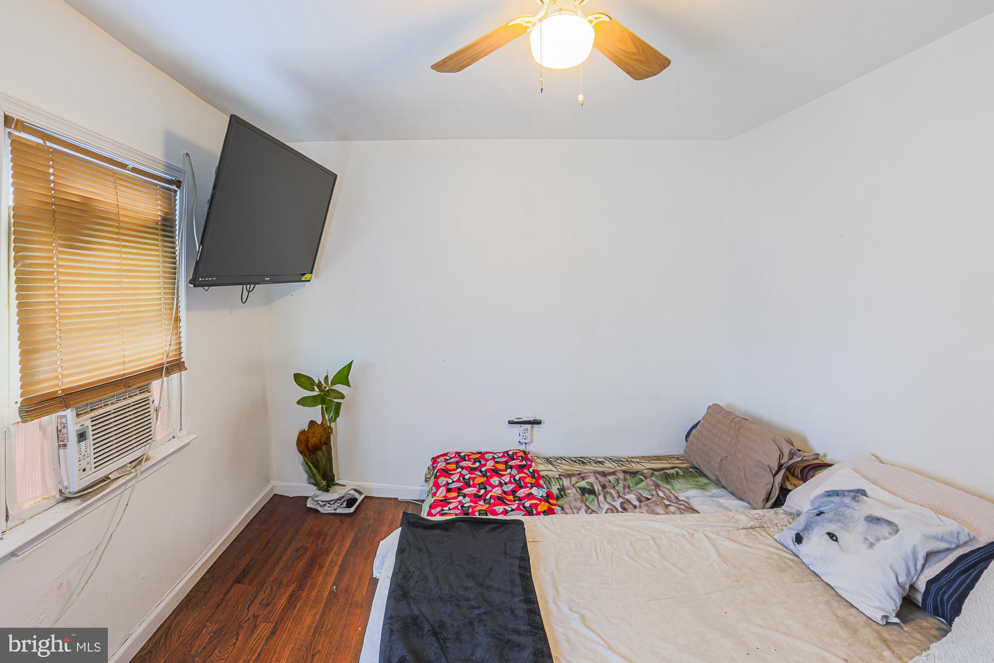 2707 Norfen Road Baltimore, MD 21227 - Photo 6 of 11 a living room with furniture and a flat screen tv