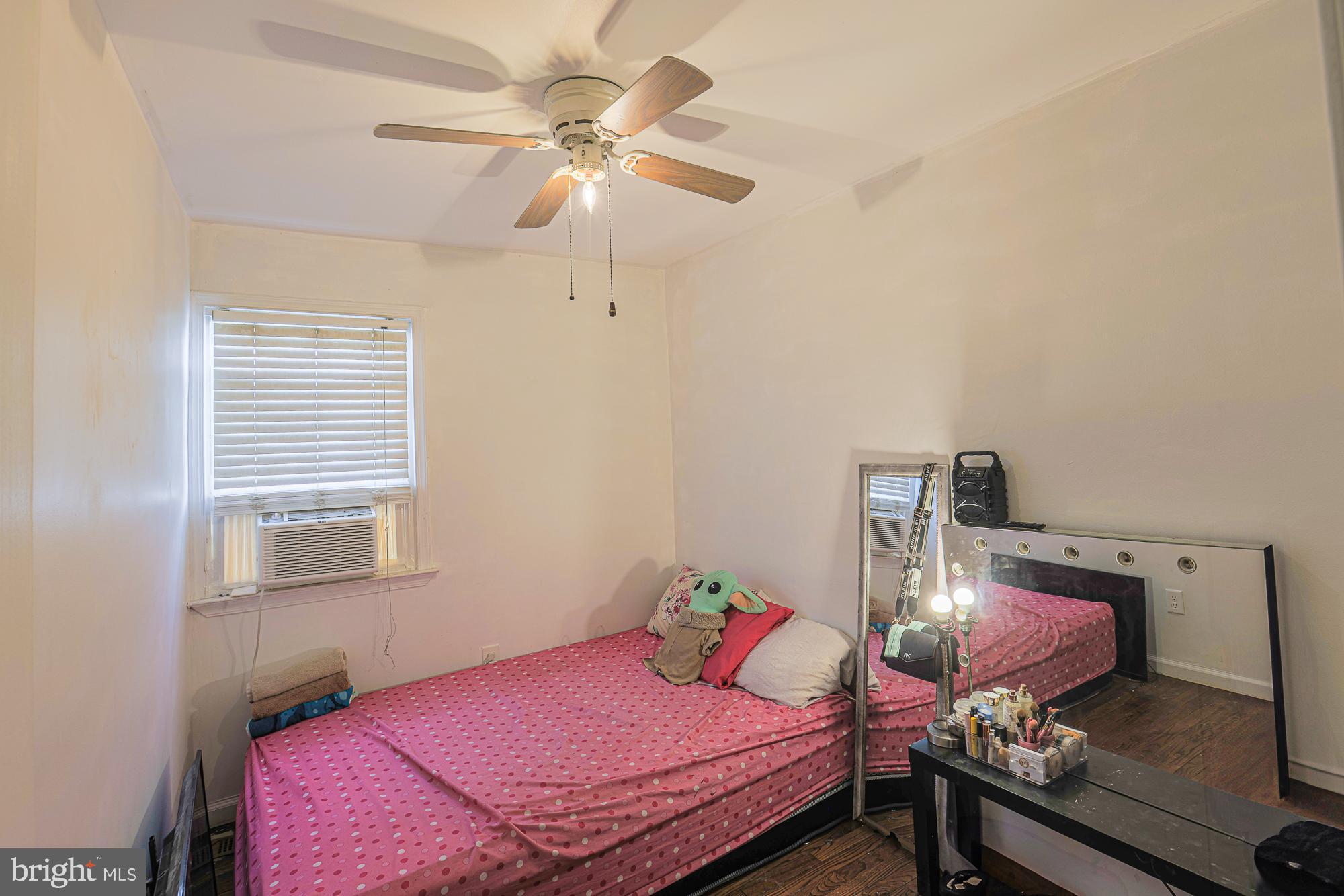 2707 Norfen Road Baltimore, MD 21227 - Photo 7 of 11 a bedroom with a bed and dresser