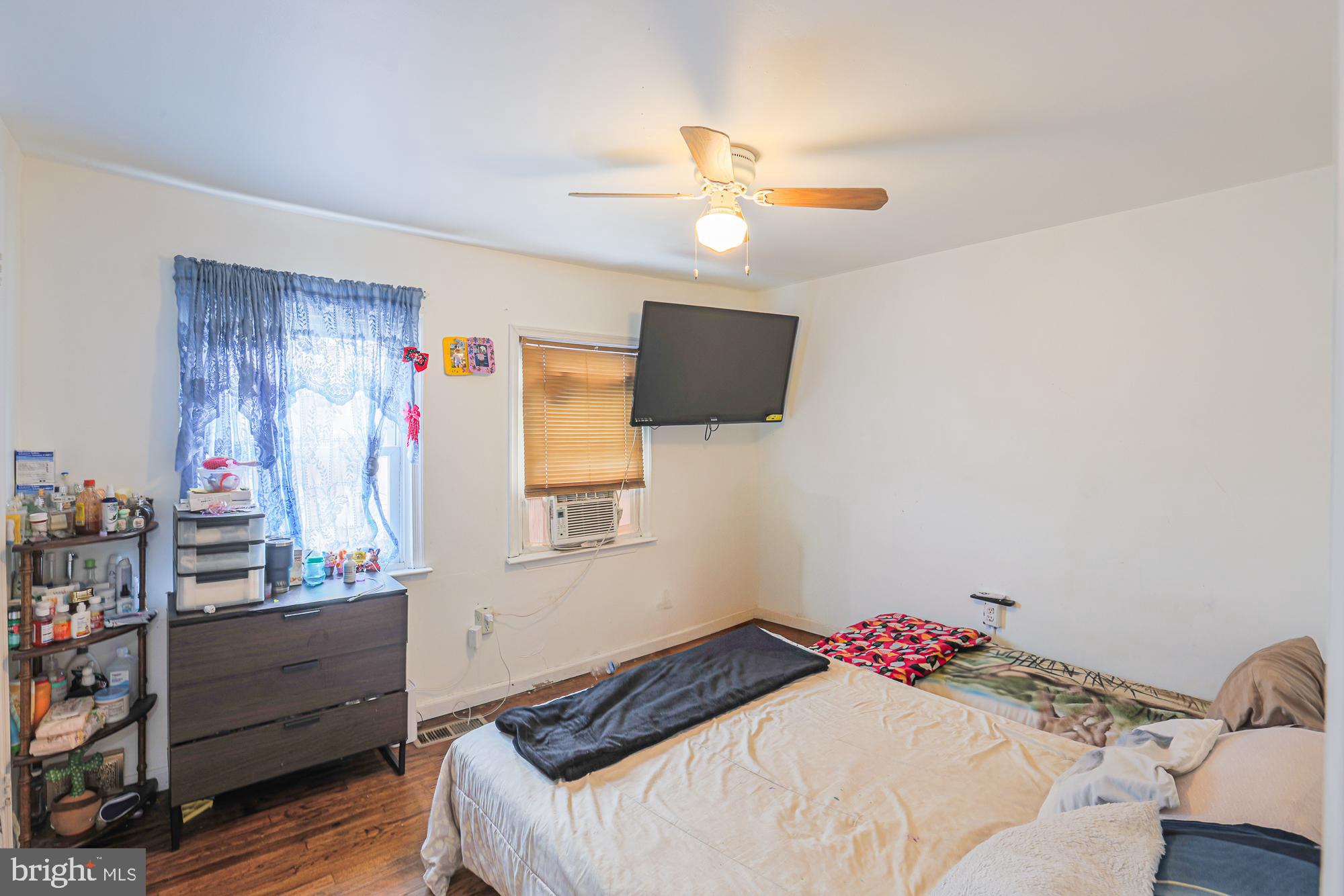 2707 Norfen Road Baltimore, MD 21227 - Photo 8 of 11 a bedroom with a bed and a chandelier