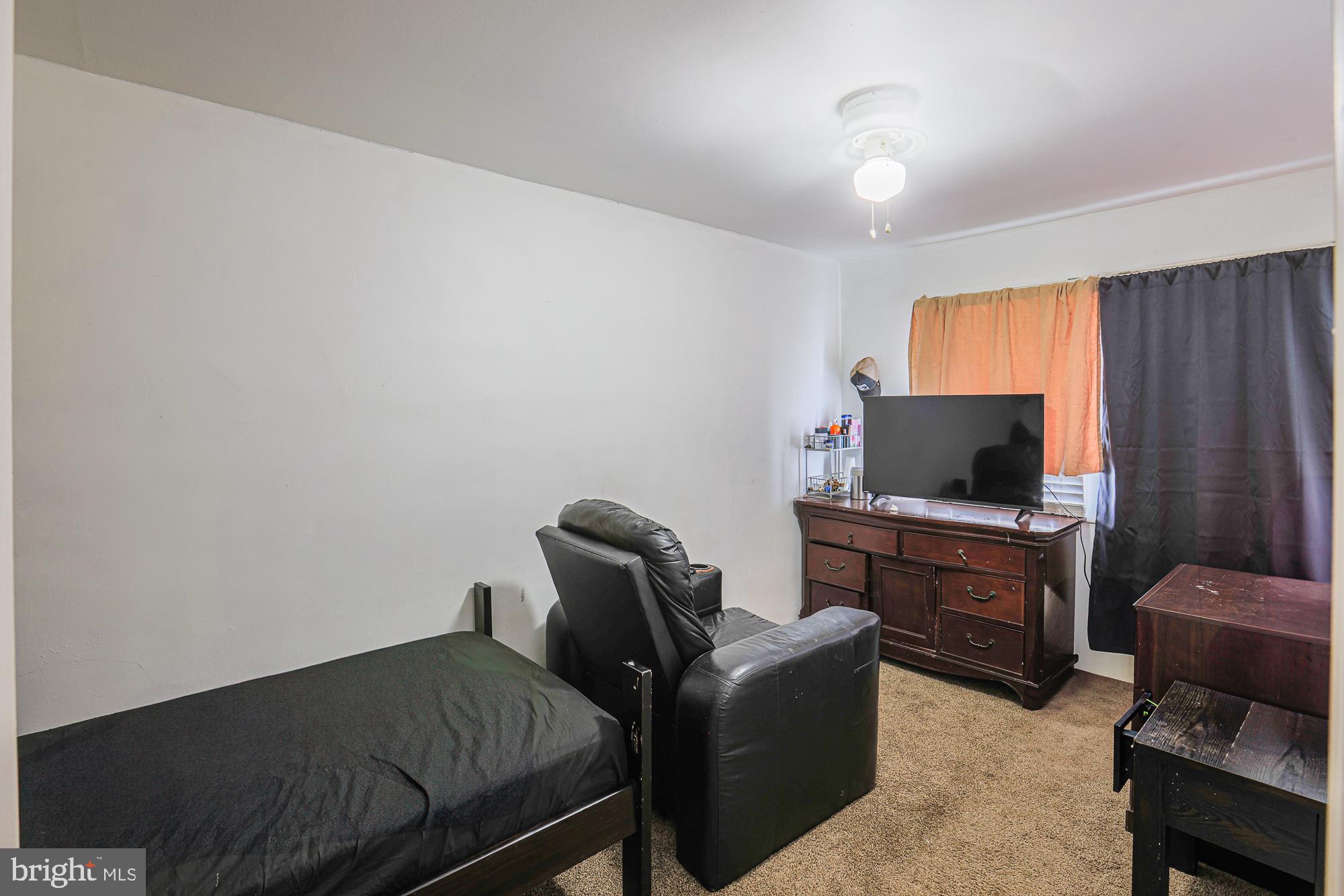 2707 Norfen Road Baltimore, MD 21227 - Photo 9 of 11 a bedroom with furniture and a flat screen tv