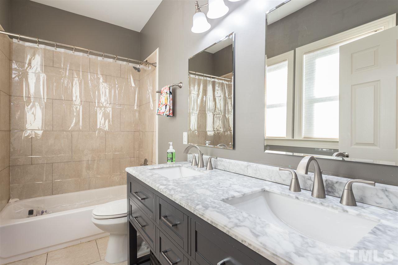 505 Holden Street Raleigh, NC 27604 - Photo 11 of 21 a bathroom with a granite countertop sink toilet and shower