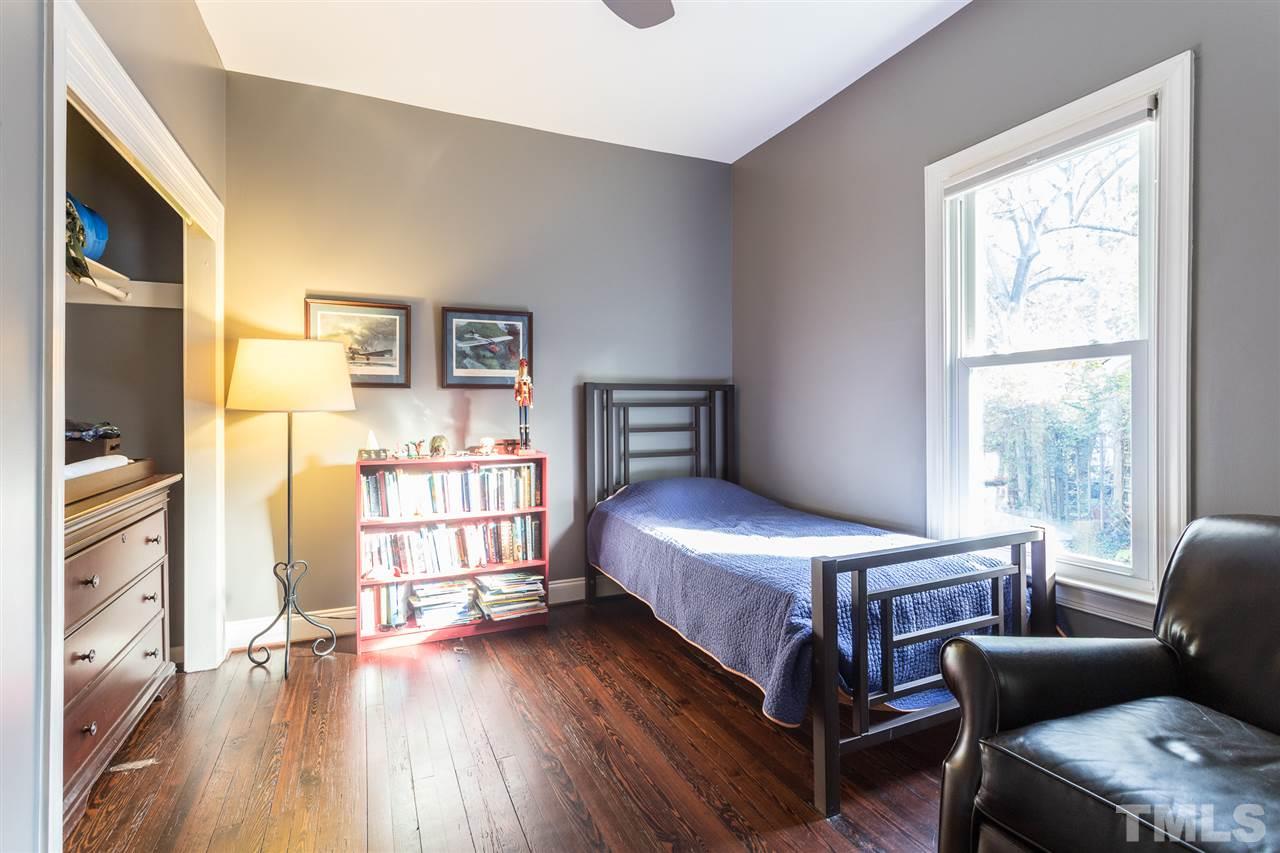 505 Holden Street Raleigh, NC 27604 - Photo 12 of 21 a bedroom with a bed and wooden floor