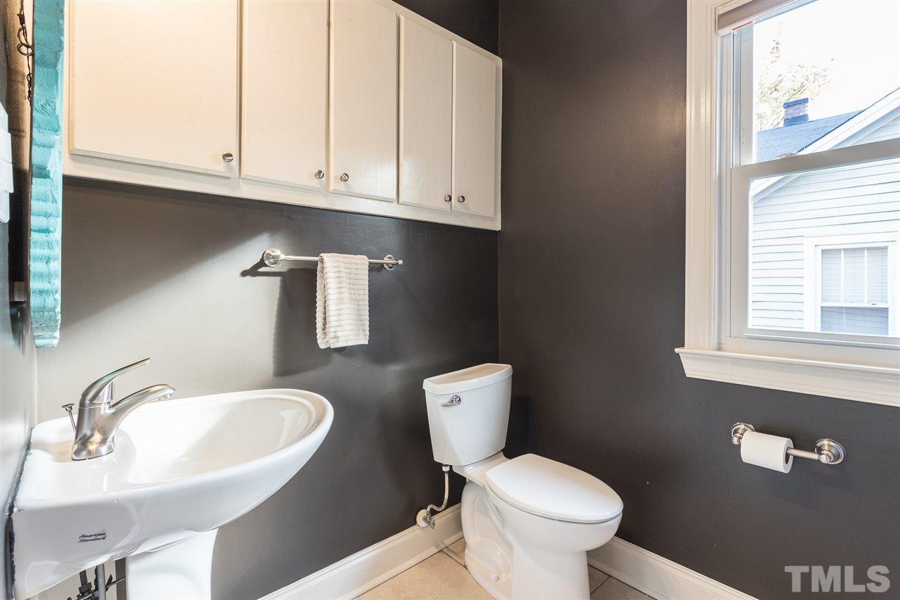 505 Holden Street Raleigh, NC 27604 - Photo 14 of 21 a bathroom with a toilet a sink and mirror