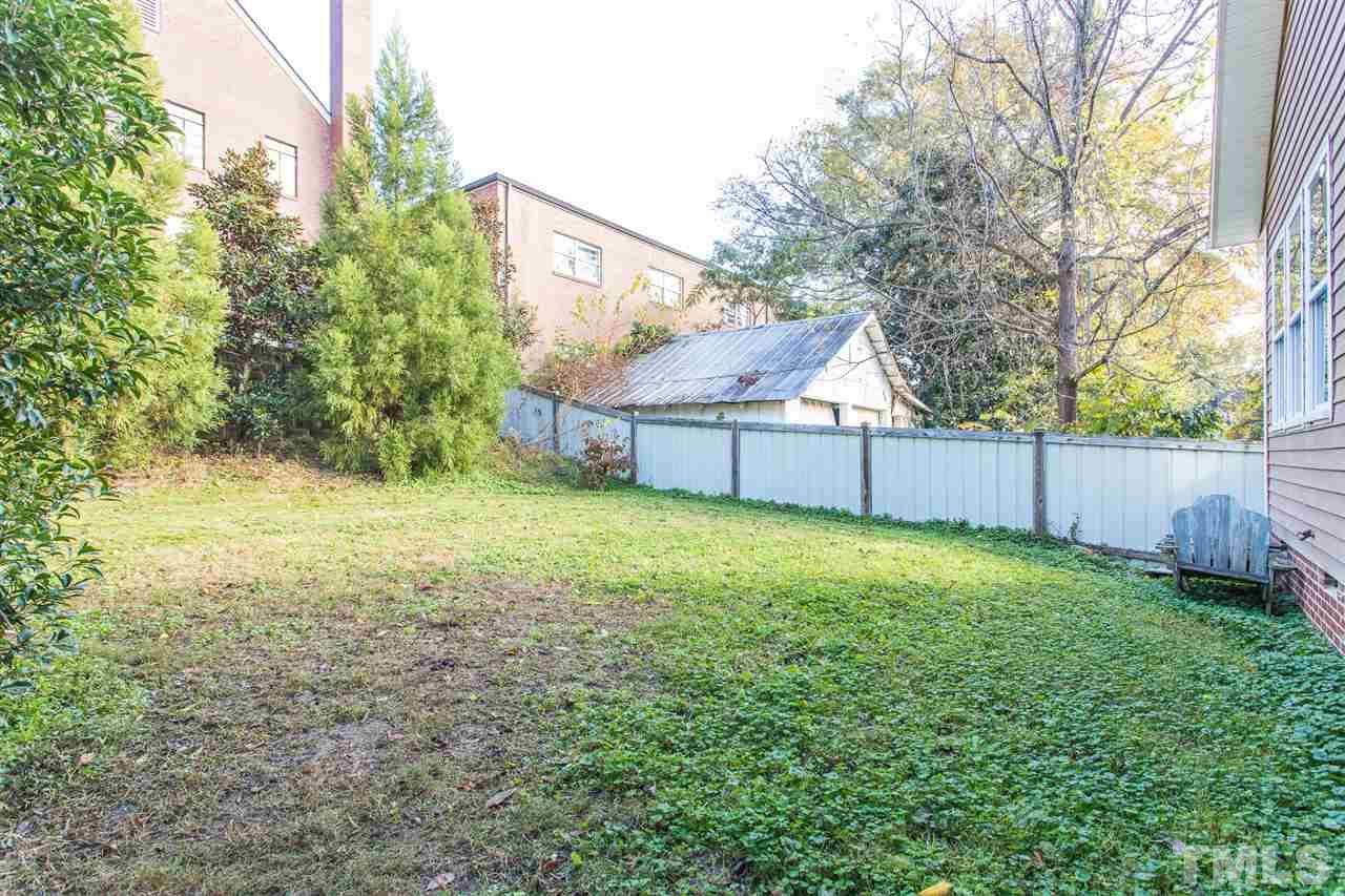 505 Holden Street Raleigh, NC 27604 - Photo 17 of 21 a view of a backyard with a garden and deck