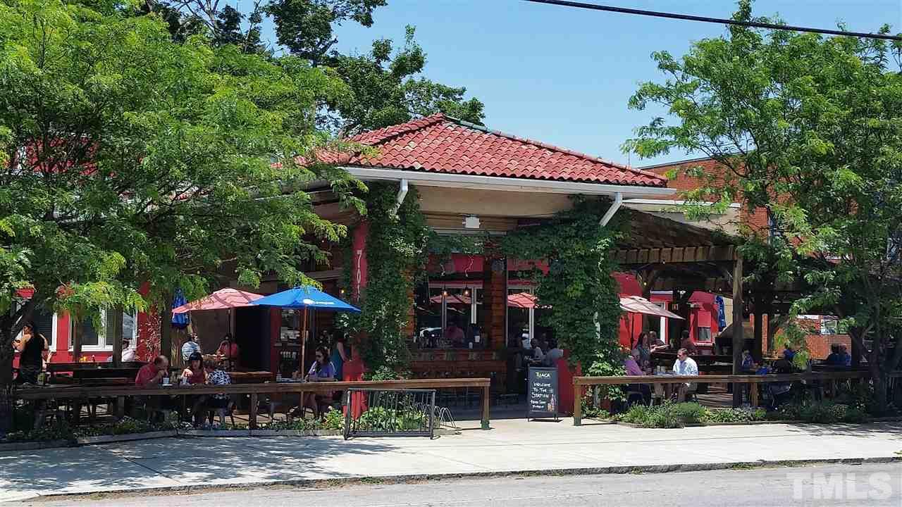505 Holden Street Raleigh, NC 27604 - Photo 18 of 21 a view of a cafe with a table and chairs under an umbrella