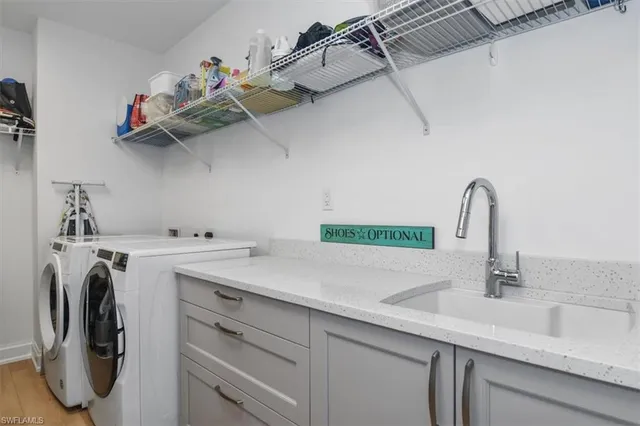 a view with a sink and a washer dryer