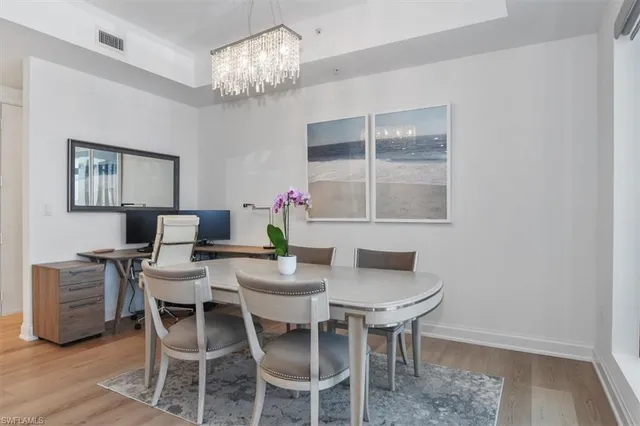 a view of a dining room with furniture and chandelier
