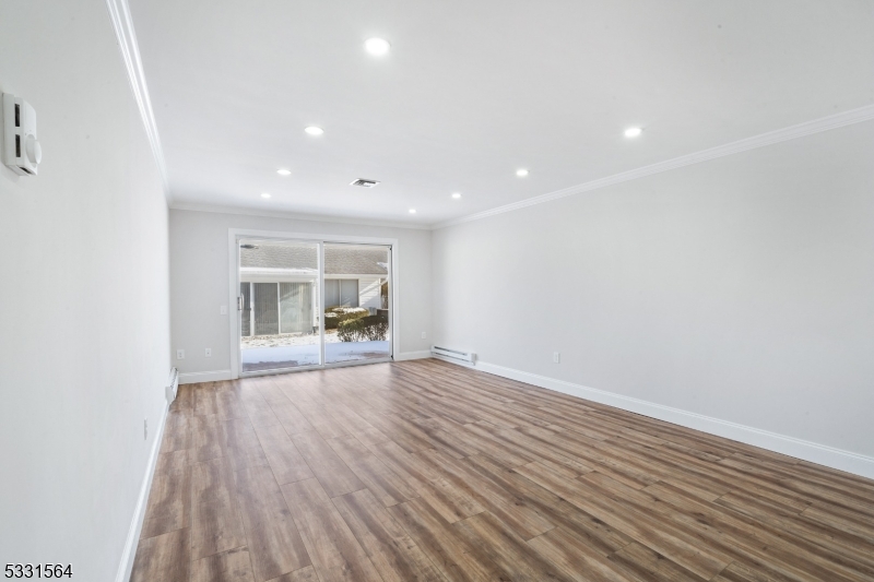 187 Newport Road Monroe Township, NJ 08831 - Photo 23 of 26 a view of empty room with wooden floor and fan