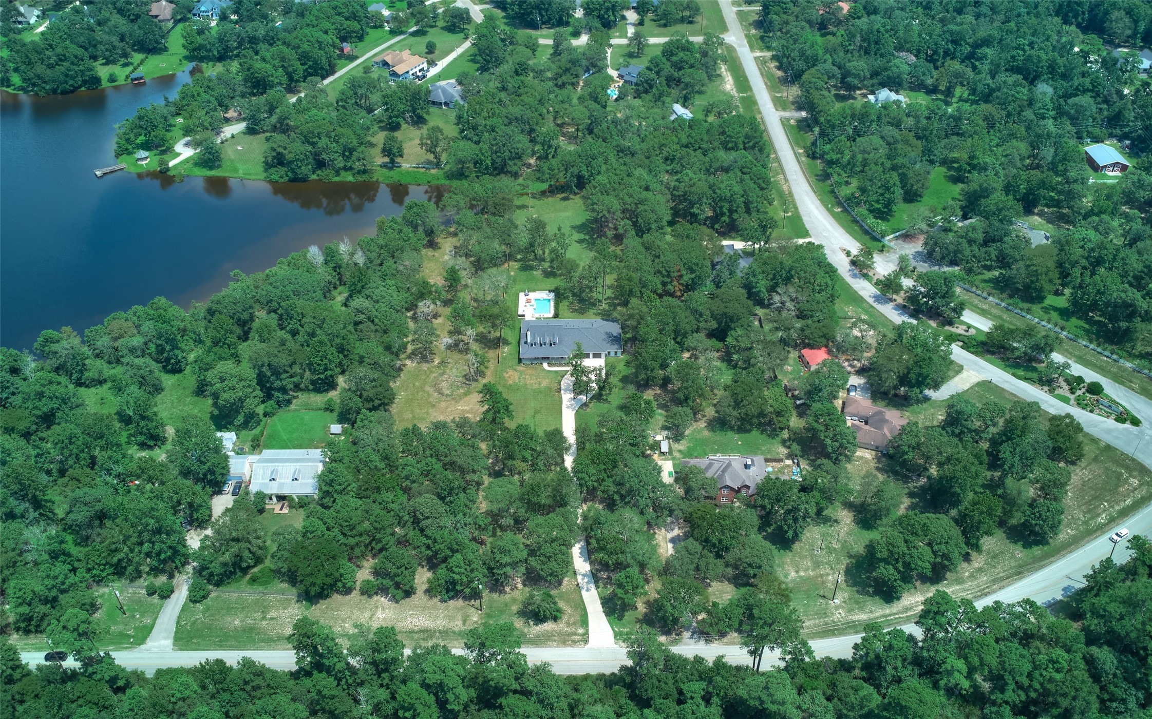 2218 Honea Egypt Road Magnolia, TX 77354 - Photo 49 of 50 Discover the serene lakeside retreat of 2218 Honea Egypt Rd, nestled on a sprawling 2.3-acre waterfront estate.
