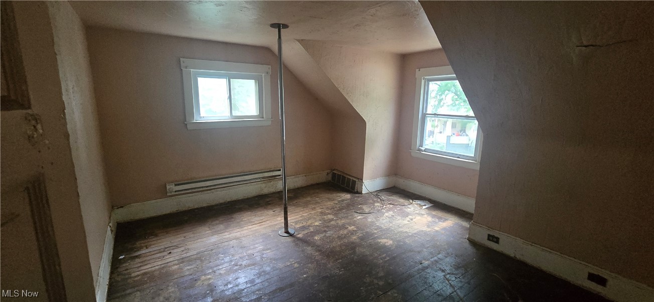 445 Cleveland Road Cleveland, OH 44108 - Photo 3 of 10 Bonus room with plenty of natural light, a baseboard heating unit, and dark wood-type flooring