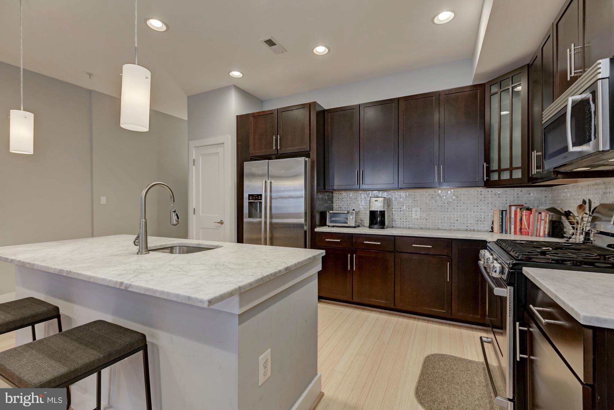 1202 Fairmont Street Northwest, Unit 2 Washington, DC 20009 - Photo 12 of 26 Abundant 42" walnut stained cabinets & pantry