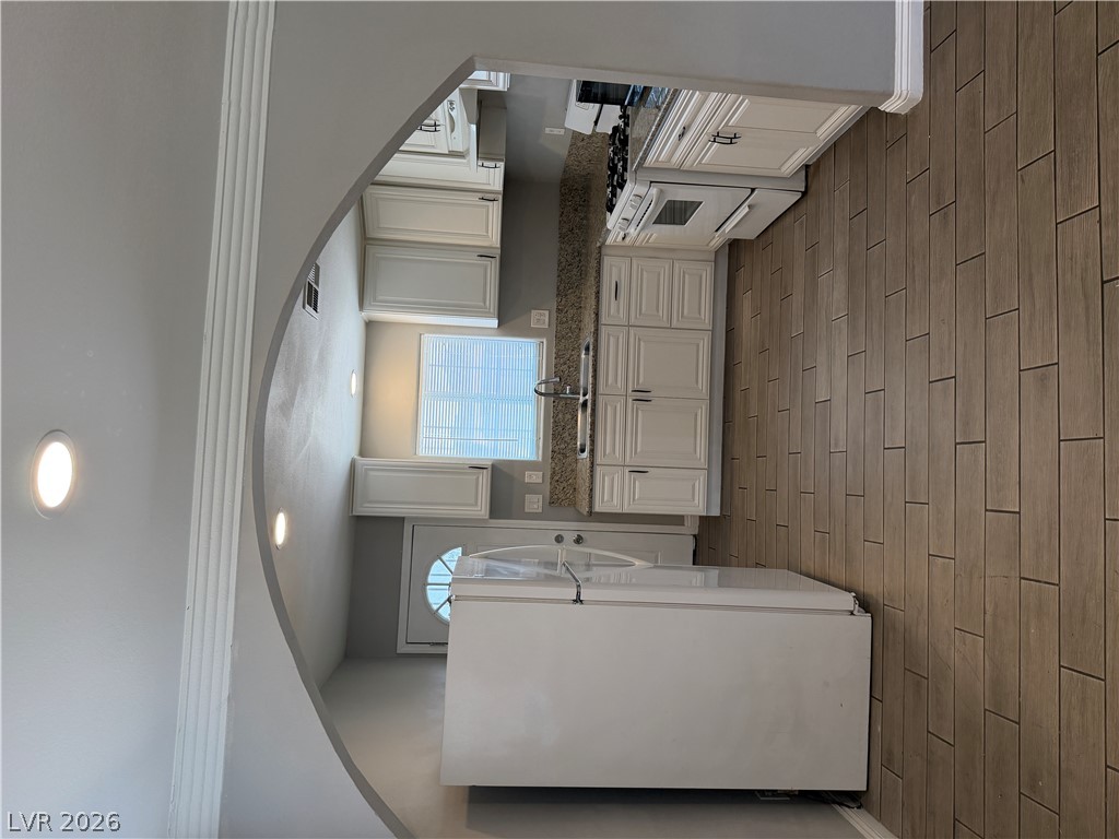 2820 South Sandhill Road, Unit A Las Vegas, NV 89121 - Photo 9 of 26 Culinary delights await in this bright kitchen with ample counter space and stylish flooring.