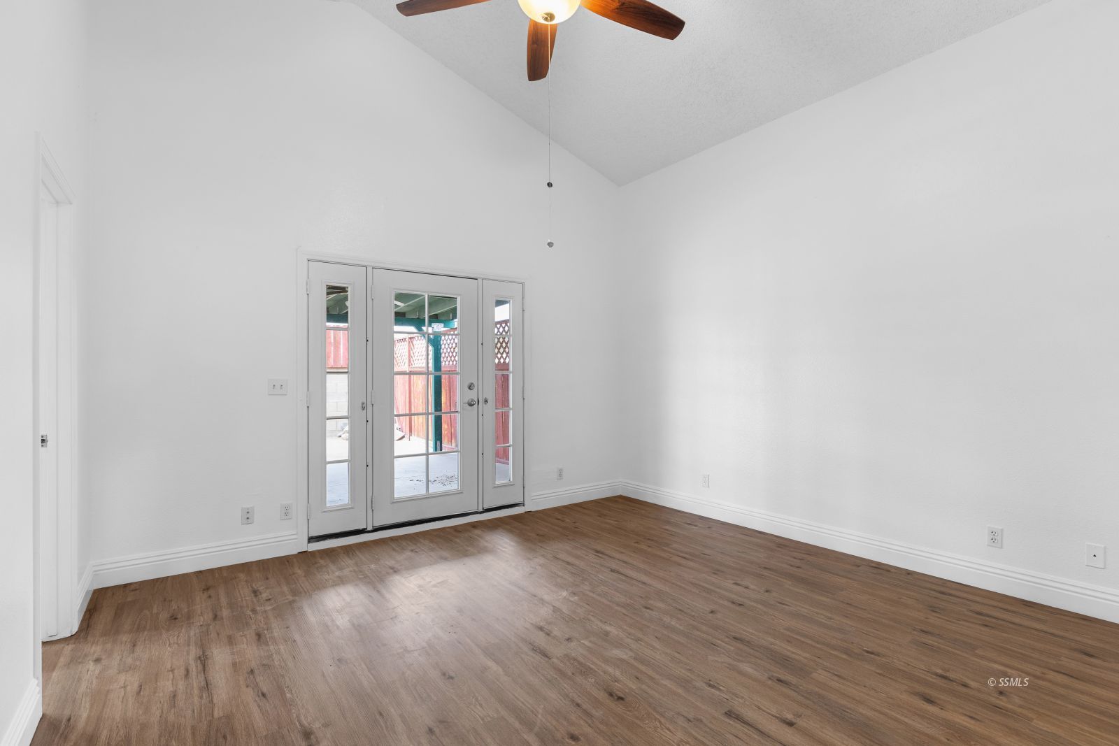 833 Charles Court Ridgecrest, CA 93555 - Photo 13 of 30 an empty room with chandelier fan and windows