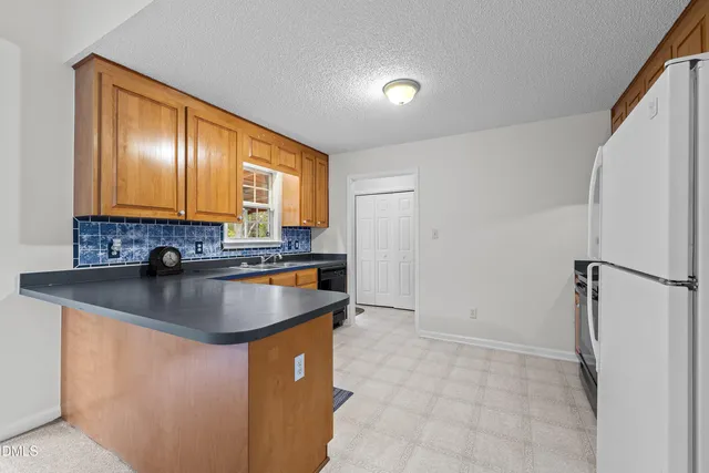 a kitchen with stainless steel appliances granite countertop a sink dishwasher and cabinets with wooden floor